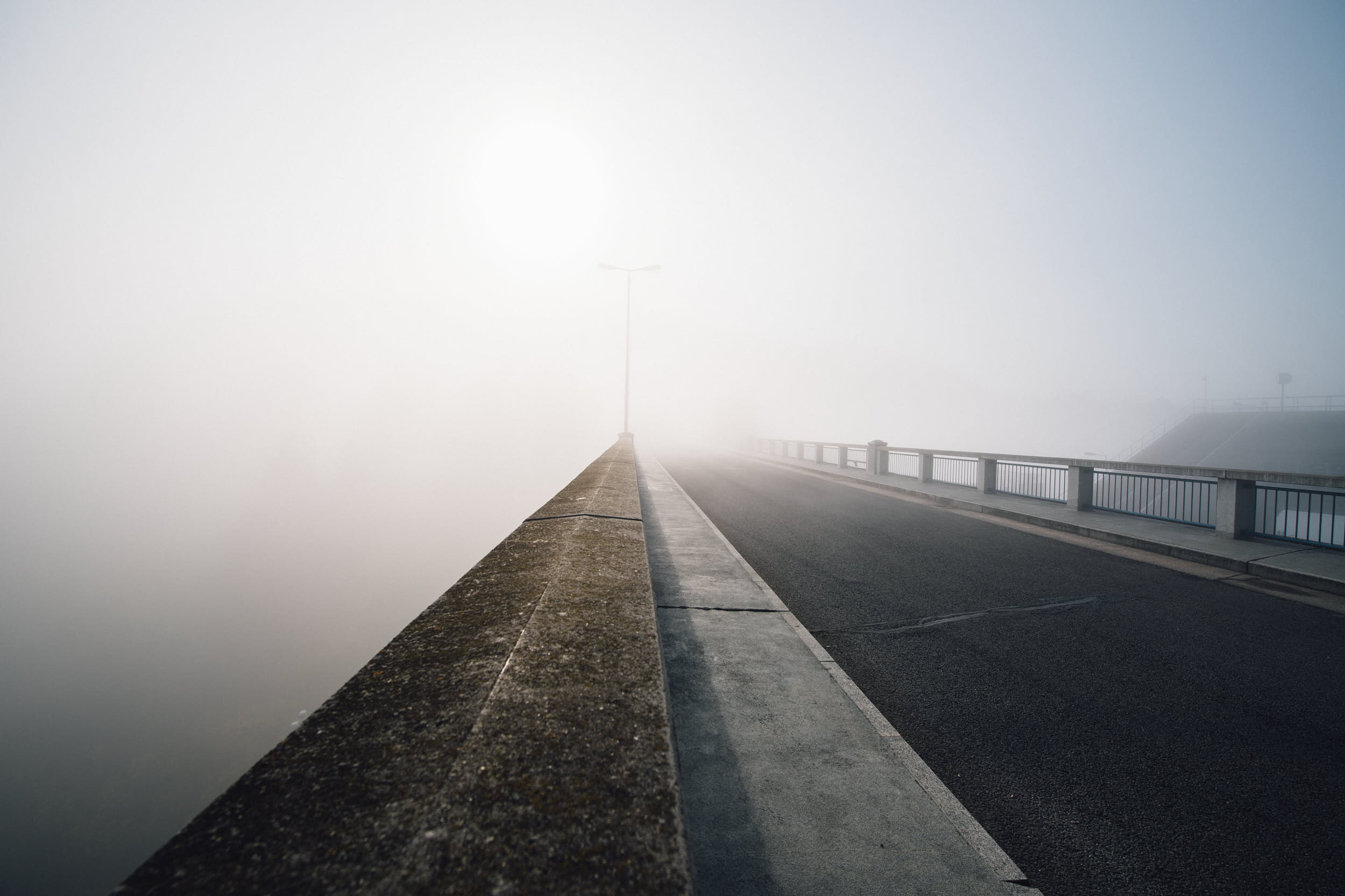 Minimal landscape photography: foggy morning on a bridge.