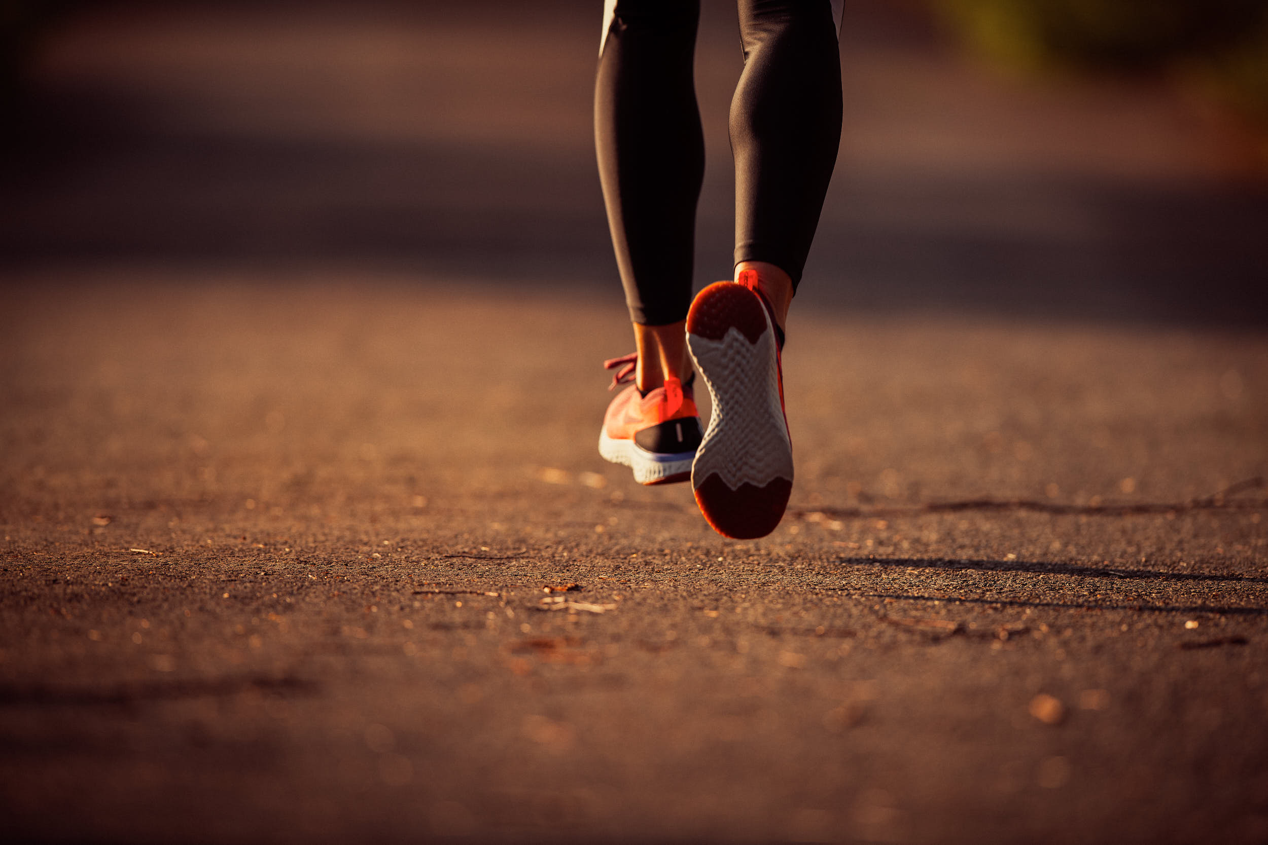 Detail of a running shoe during action in morning light.