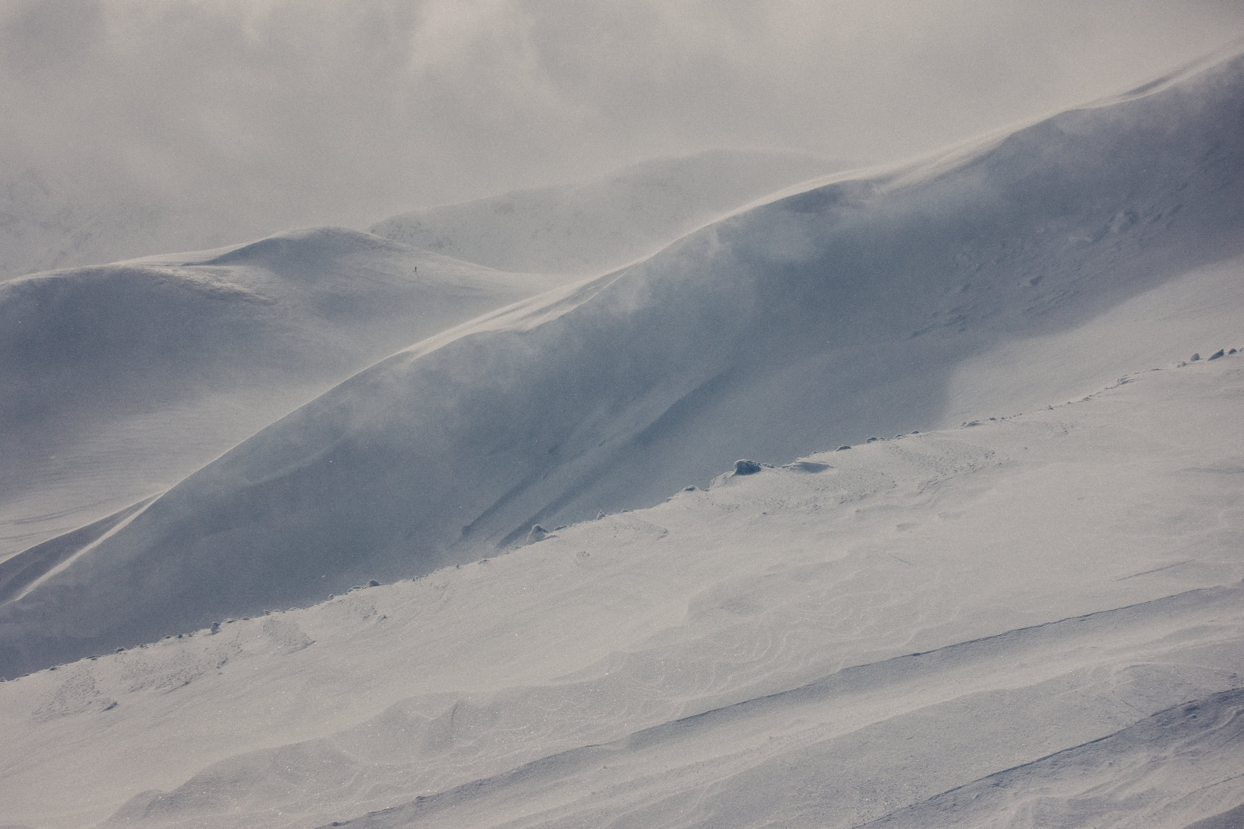 Snowy landscape of a mountain ridge during a blizzard.