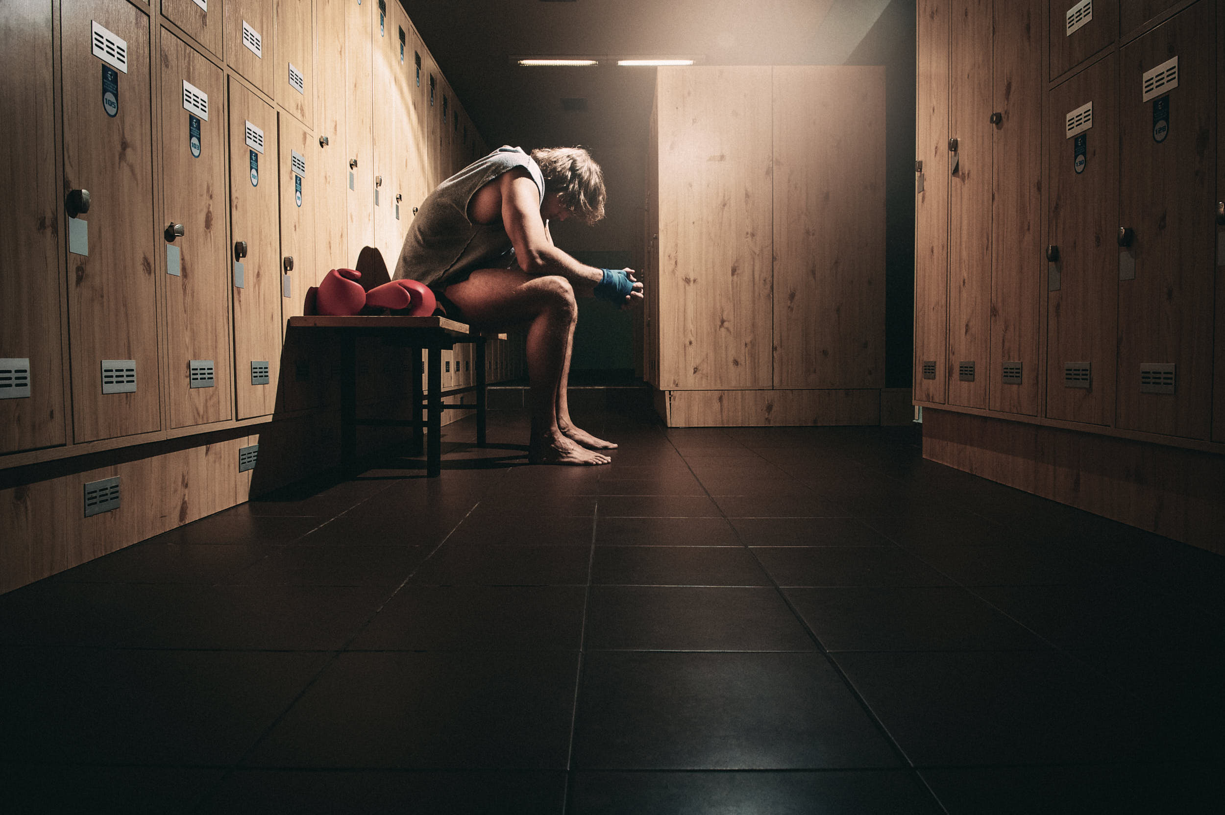 action sports advertising photography: boxer sitting in a locker room preparing for the fight.