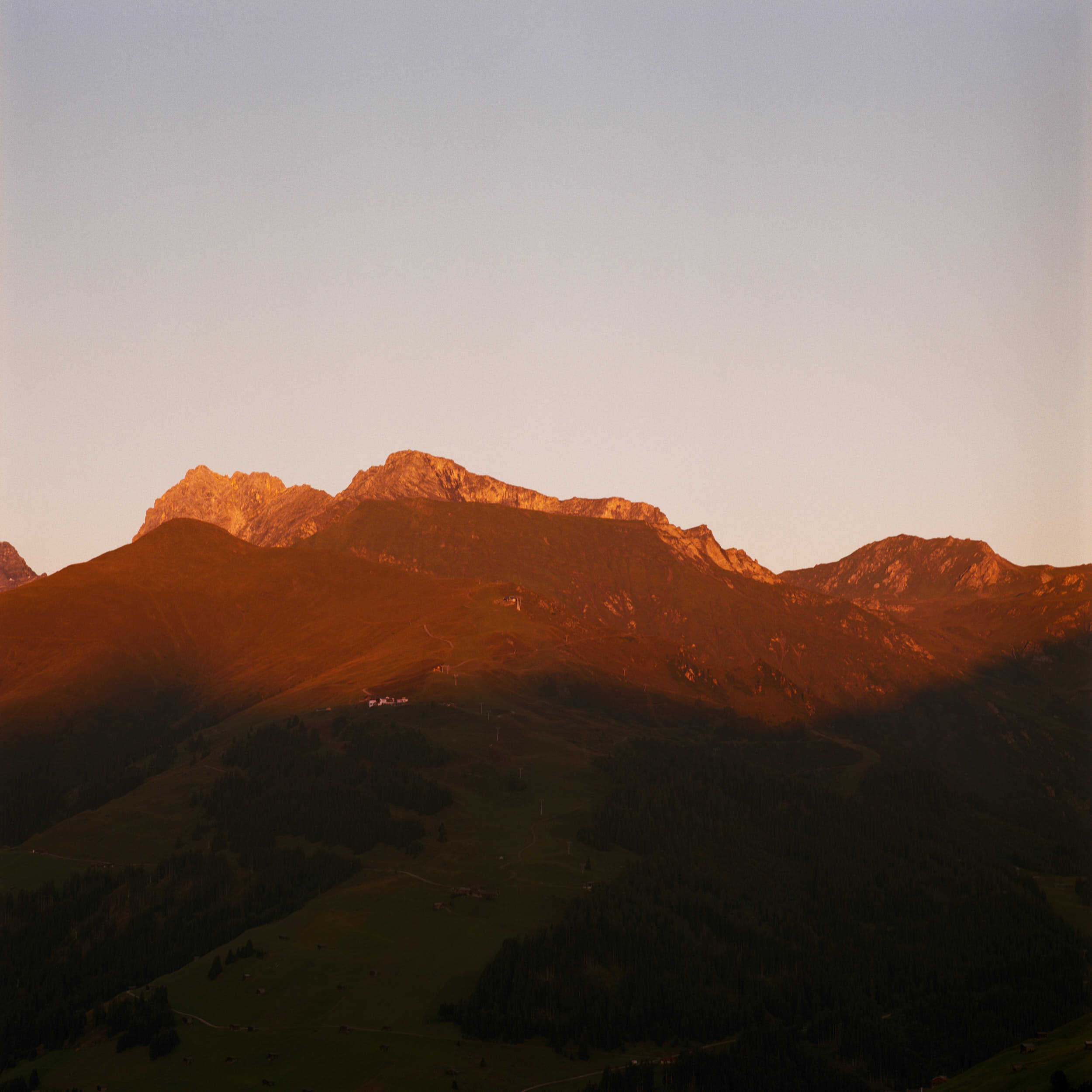 First sunlight hitting the top of alpine peaks. Shot on medium format color film.