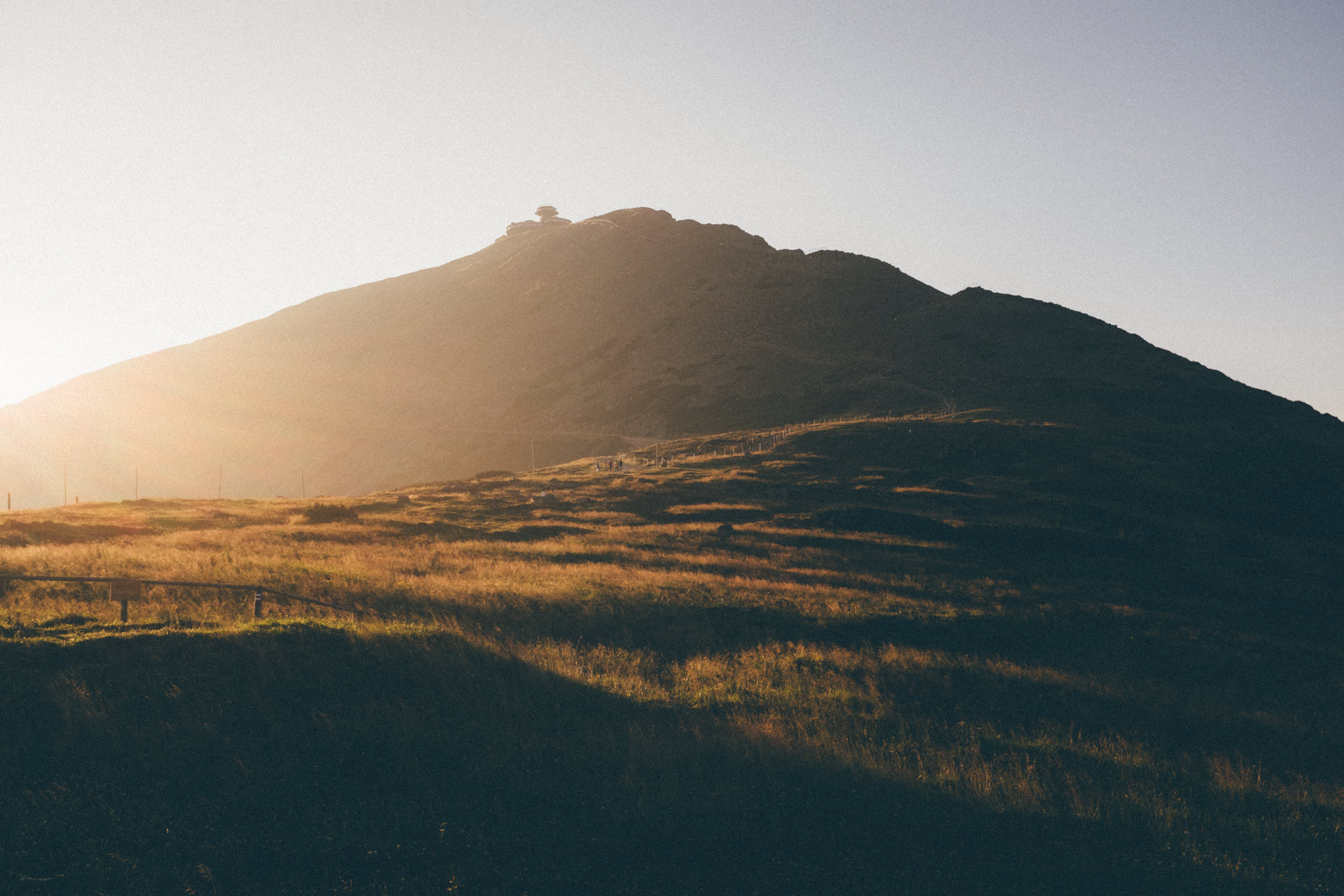 Moody landscape photography: high mountain peak in first morning light.