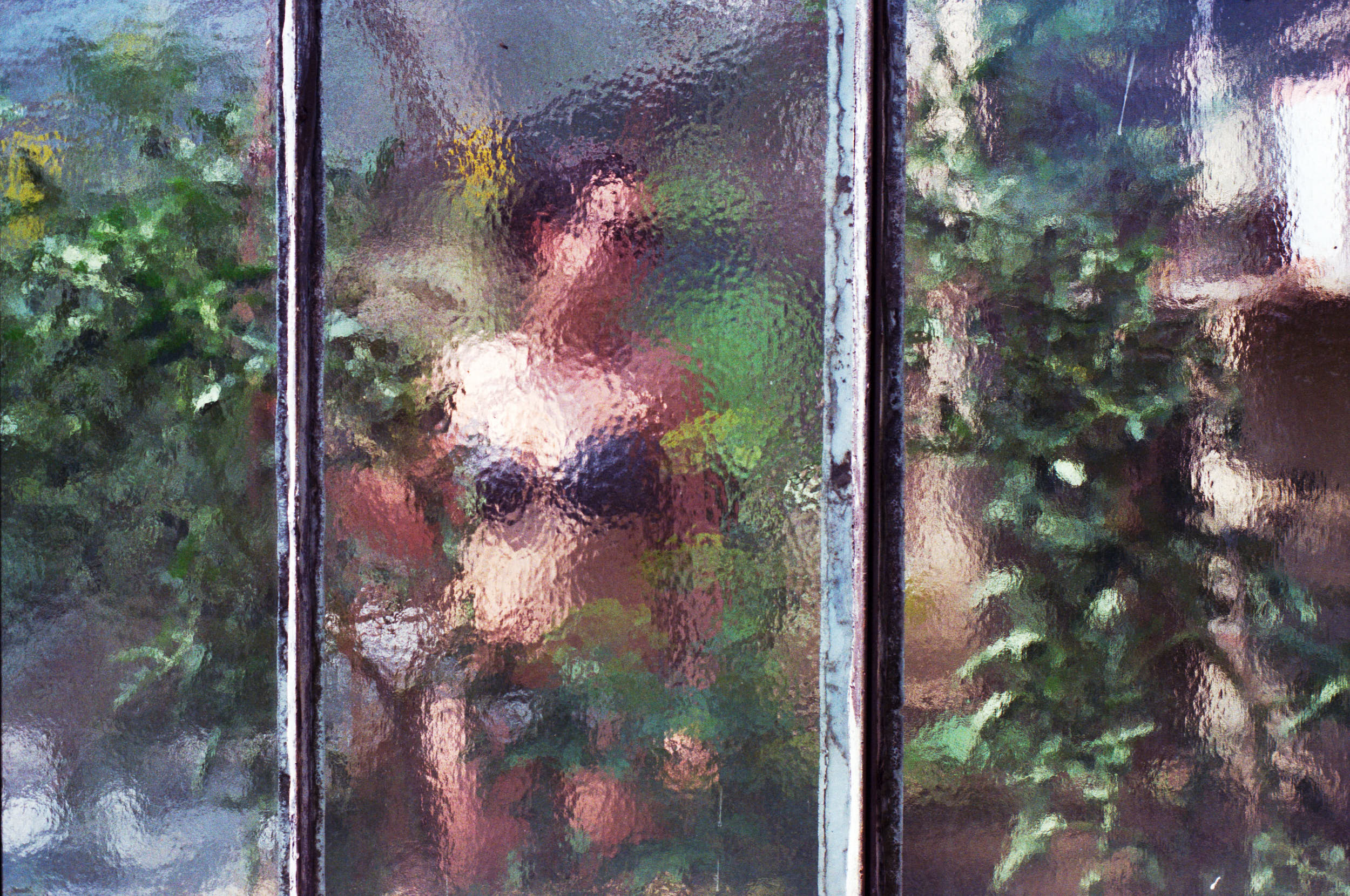 Abstract portrait of a girl shot through frosted glass.