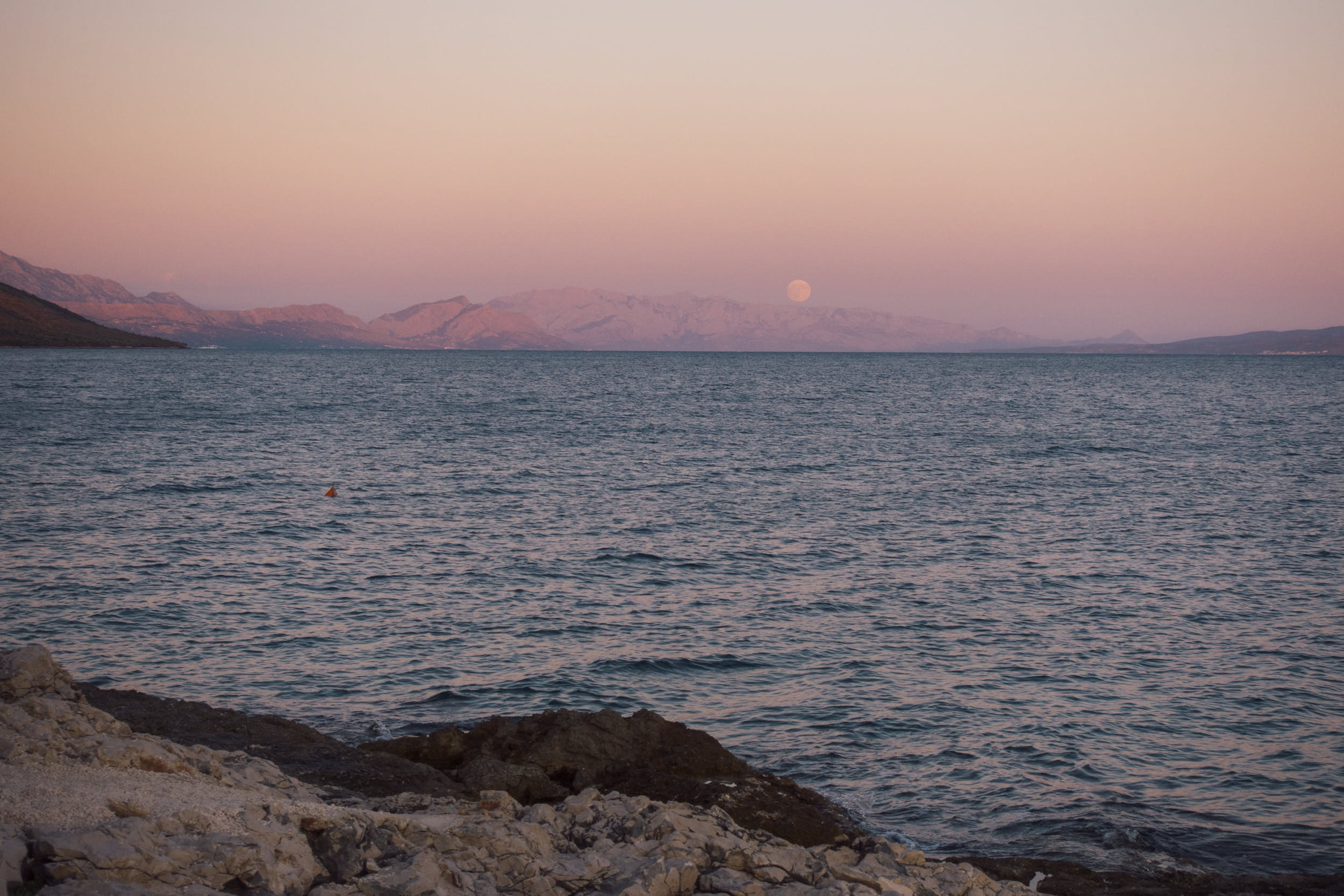 Beautiful seascape with moon rising in the distance.