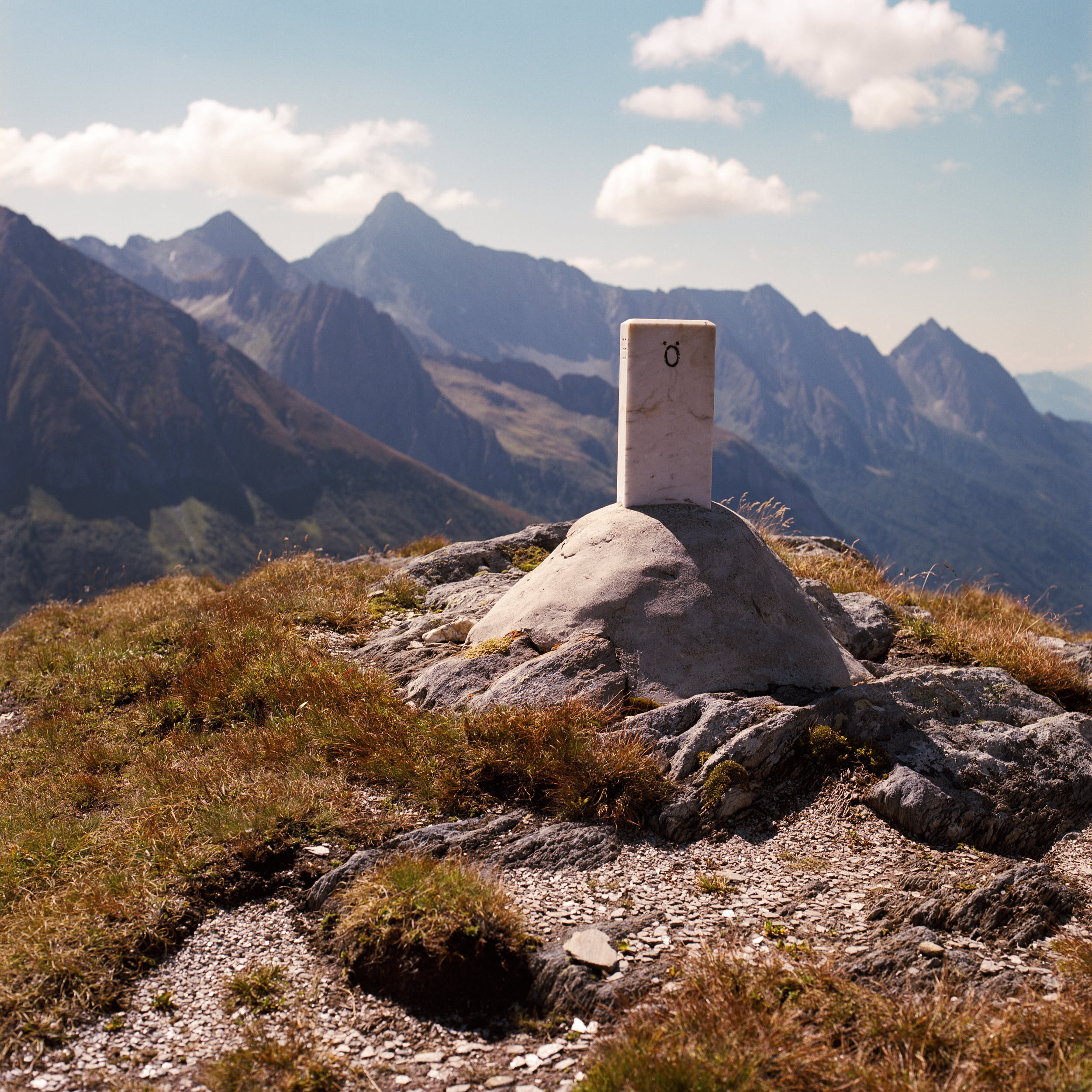 A marble stone which marks the border between Austria and Italy on a mountain pass.