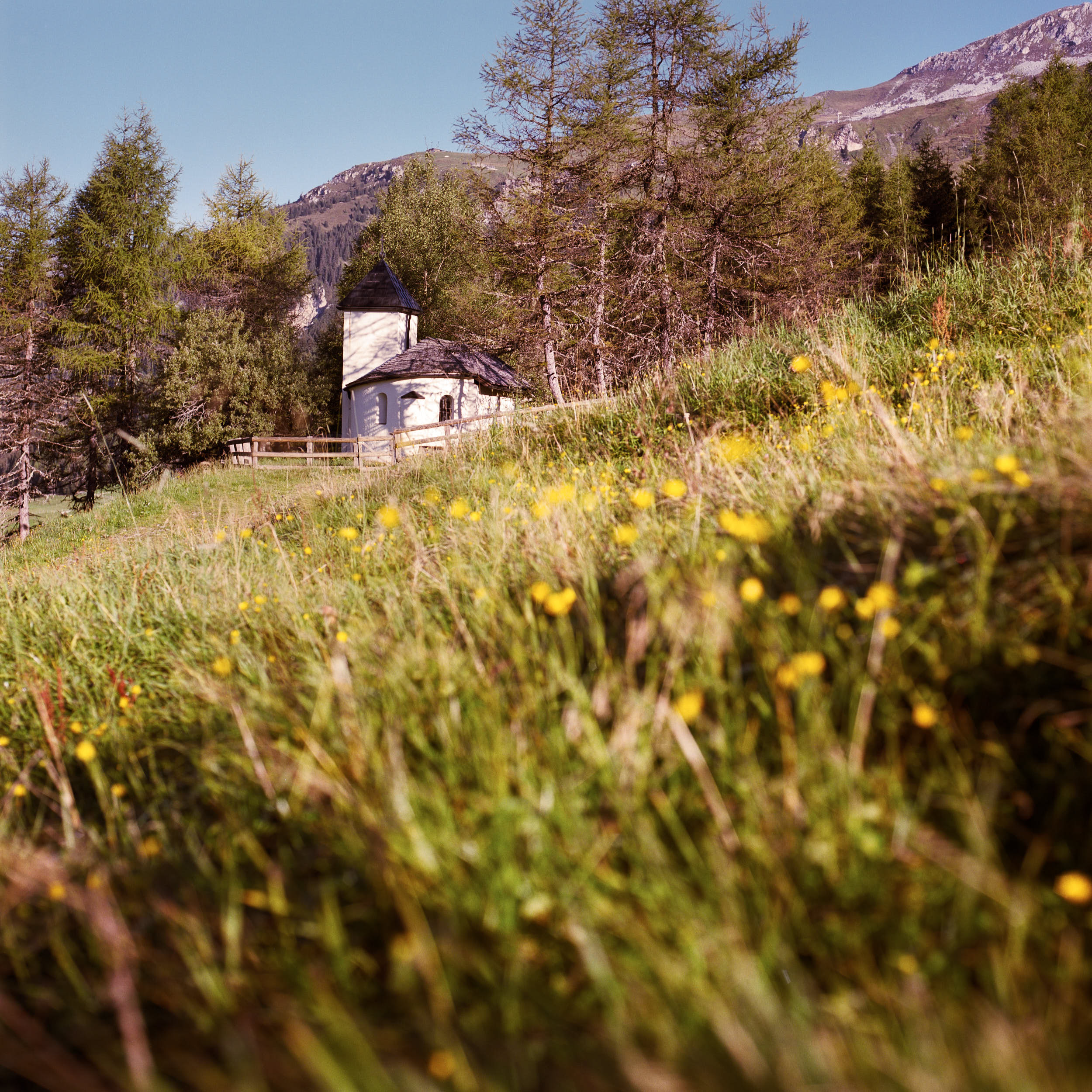 Mountain landscape photography: small mountain chapel on an alpine meadow.