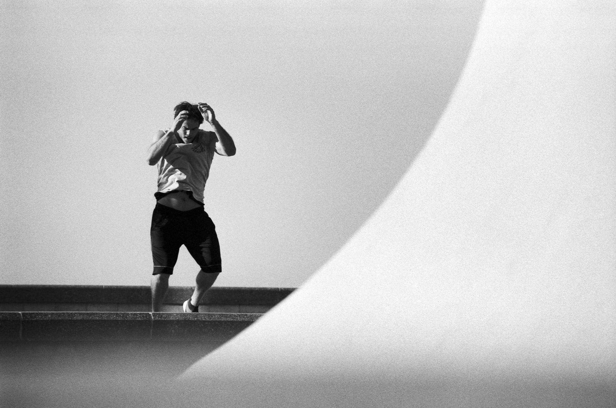 Fitness athlete working out in a black and white geometrical composition.